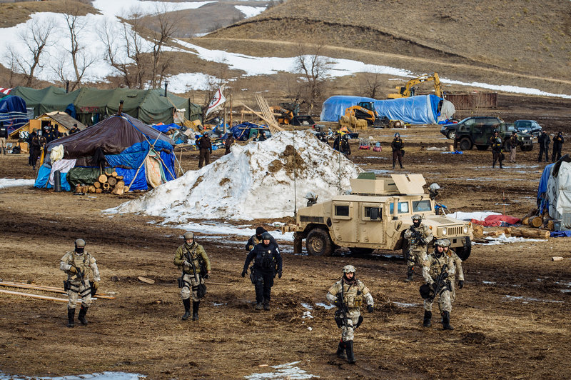 Police move through the camp of protesters against the Dakota Access Pipeline near Cannon Ball, N.D.jpg